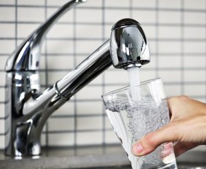 Filling glass of water from stainless steel kitchen faucet