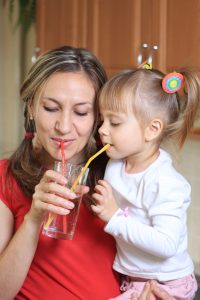 Mother and litte child Sipping water together